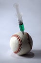 Baseball and syringe on a light background Royalty Free Stock Photo