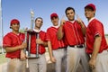 Baseball team-mates holding trophy