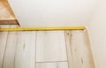 Baseboard installation. Repair works indoors. Renovation in the flat. Tape measure