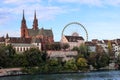 Basel Munster church in the river Rhine with the big ferris wheel