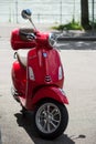 Front view of red vespa scooter parked in the street Royalty Free Stock Photo