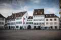 Warmly dressed people walk on cathedral square of Basel