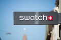 Swatch logo on signboard on store front in the street