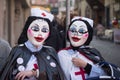 Masked women wearing nurse costume parading in the street