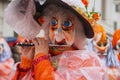 Women plays flute during parade at Carnival in Basel, Switzerland.