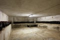 Basement with wine bottles and wooden table in old house interior Royalty Free Stock Photo