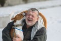 Basenji dog licks master`s ear discharging it`s everyday obligations