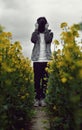 Bashful boy standing with hat in field Royalty Free Stock Photo