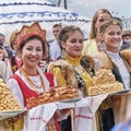 Bashkir and Russian girls in national festive clothes holding traditional pies at Sabantuy holiday