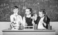 Basic chemical reactions. Group school pupils study chemistry in school. Boy and girls enjoy chemical experiment