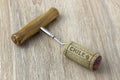 A basic corkscrew with a cork on a wooden table. Name of wine country Chile is written on cork Royalty Free Stock Photo