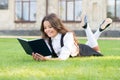 Basic education. Educational book. Literature for kids. Lesson on fresh air. Cute small child reading book outdoors