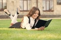 Basic education. Educational book. Literature for kids. Lesson on fresh air. Cute small child reading book outdoors