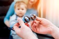 Basic eye examination. Mother holds child during eye exam.