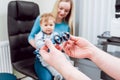 Basic eye examination. Mother holds child during eye exam.