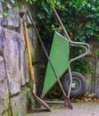Basic gardening equipment, a wheelbarrow with a shovel and rigid, Garden upkeep tools Royalty Free Stock Photo