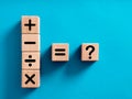 Basic mathematical operations symbols. Plus, minus, multiply, divide, equal and question mark symbols on wooden cubes