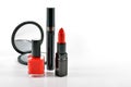 Basic red makeup cosmetics on white background.