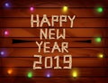2019 Happy New Year with letters and numbers wood on wooden background