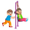 brother pushing sister on swing Royalty Free Stock Photo