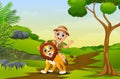 Happy zookeeper boy and lion in a park Royalty Free Stock Photo