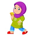 Moslem girl walking and carrying holy Quran