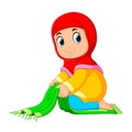 The deligent girl is folding her green prayer rug Royalty Free Stock Photo