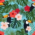 Seamless tropical pattern, monstera and palm leaves, bright chinese rose flowers, toucan birds on a blue background.