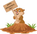 Happy groundhog day. Funny groundhog holding wooden sign Royalty Free Stock Photo