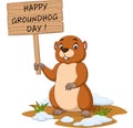 Happy groundhog day. Funny groundhog holding wooden sign Royalty Free Stock Photo