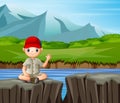 The explorer boy sitting on the cliff