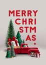 Christmas composition with christmas trees,  vintage toy red pickup truck and gift box. Royalty Free Stock Photo