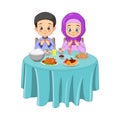 Muslim man and woman pray together before Iftar