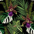 Exotic flowers seamless pattern. Tropical violet green orchid flowers and palm leaves in summer print.