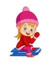 Cute little girl sledding down a hill