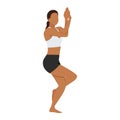 Woman doing eagle pose Garudasana exercise.