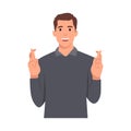 Young man Crossed Fingers with smile. Guy Making a Wish. Royalty Free Stock Photo