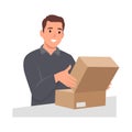 Young man Unpacking paper box concept. Young smiling man opens parcel Royalty Free Stock Photo