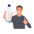 Healthy young man showing bottle of mineral water and give thumb up Royalty Free Stock Photo
