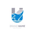 Initial Letter U Whale Jumping in the Water Logo Design Vector Icon Graphic Emblem Illustration Royalty Free Stock Photo