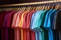 Basic t-shirts of different colors on a hanger in the store close-up