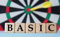 BASIC - word on wooden cubes on dartboard background