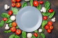 basil, champignons and tomatoes laid out in a circle Royalty Free Stock Photo