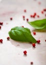 Basil leaves and pink peppercorns