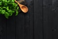 Basil plant in a pot on black wooden table