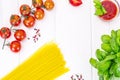 Basil, Red Cherry Tomato with Pasta on White Woody Background Royalty Free Stock Photo