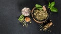 Basil salt is a natural spice with sea salt and fresh basil as seasoning on a dark background, Long banner format. top Royalty Free Stock Photo