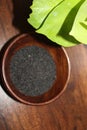 Basil seeds or sabja seeds in wooden bowl