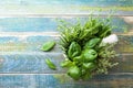 Basil, thyme, rosemary and tarragon. Aromatic herbs in mortar bowl on rustic wooden table top view. Fresh ingredients for cooking. Royalty Free Stock Photo