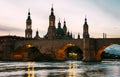 Basilica del Pilar and Puente de Piedra reflected in the Ebro river at sunset in Zaragoza, Aragon, Spain Royalty Free Stock Photo